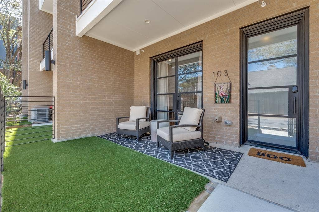 805 Pavillion Street, #103, Dallas, TX 75204 Covered patio with brick exterior, artificial turf, and a concrete walkway