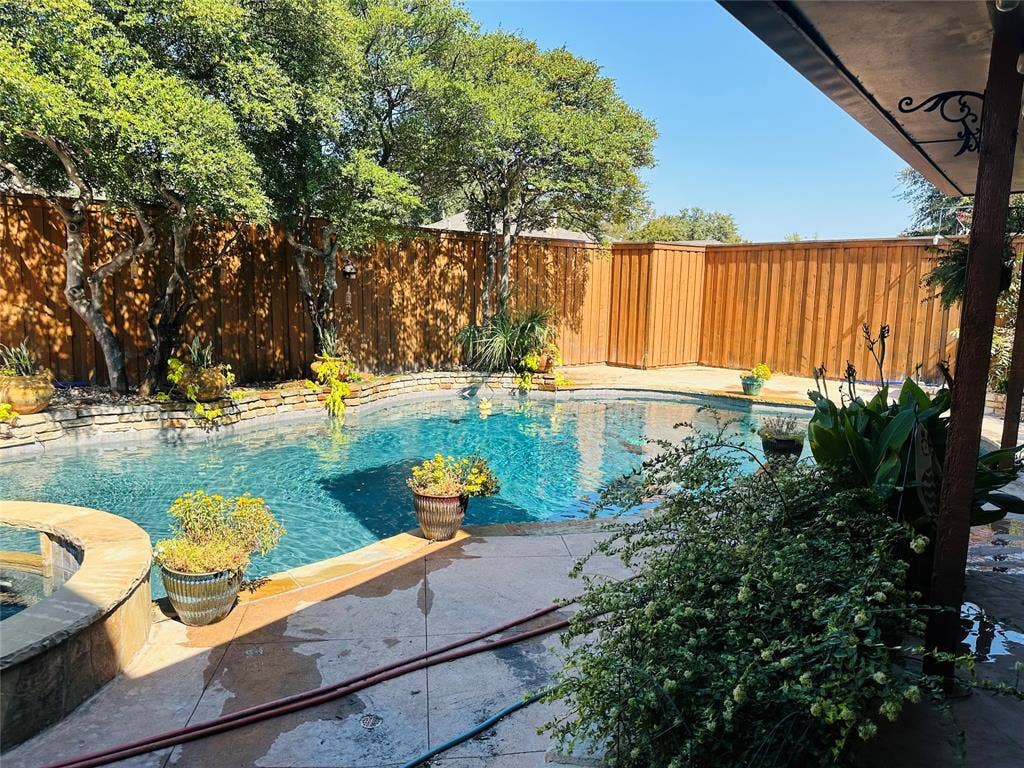 3713 San Juan Circle, Plano, TX 75023 Fenced backyard with a swimming pool, integrated spa, stone coping, concrete patio, and mature trees