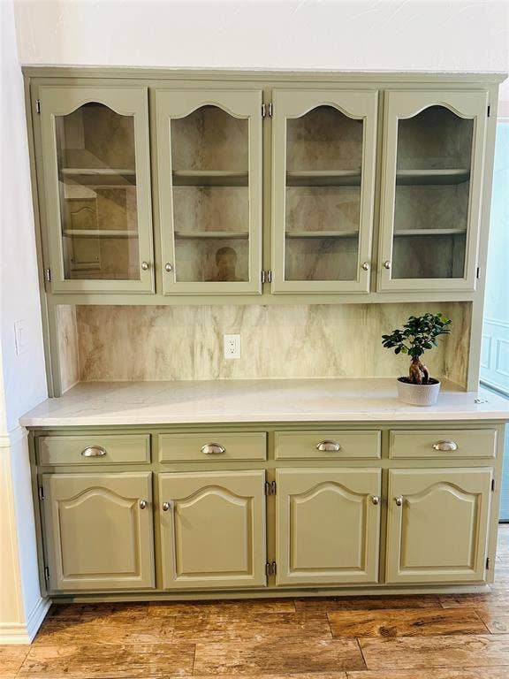 3713 San Juan Circle, Plano, TX 75023 Built-in cabinetry with glass-front upper doors, lower storage cabinets, and a solid surface countertop