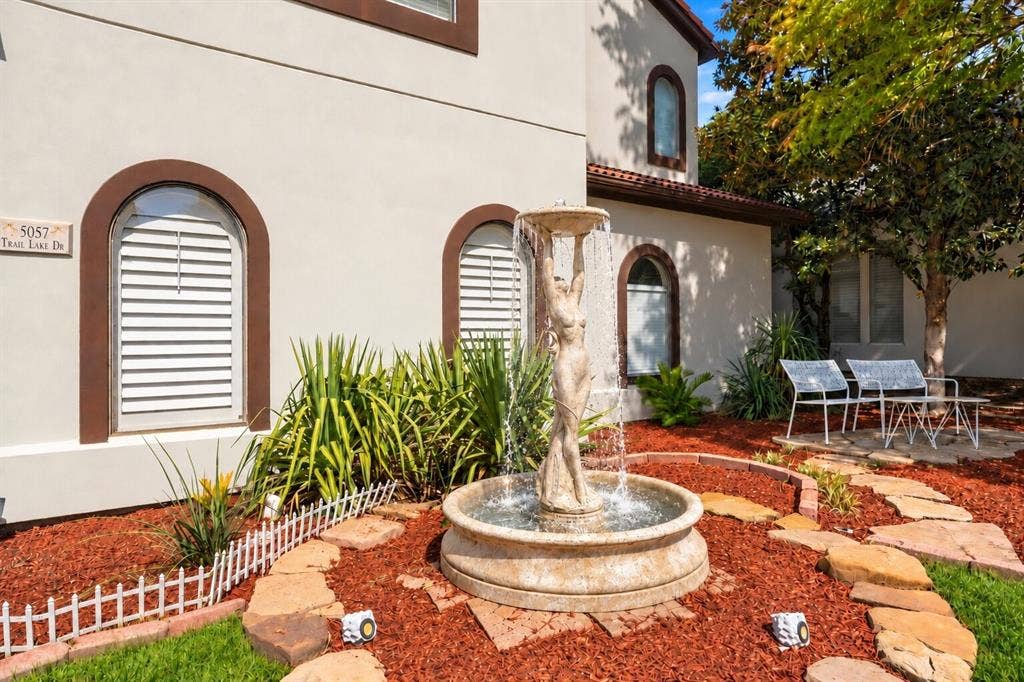 5057 Trail Lake Drive, Plano, TX 75093 Beautiful landscaping and a charming fountain.