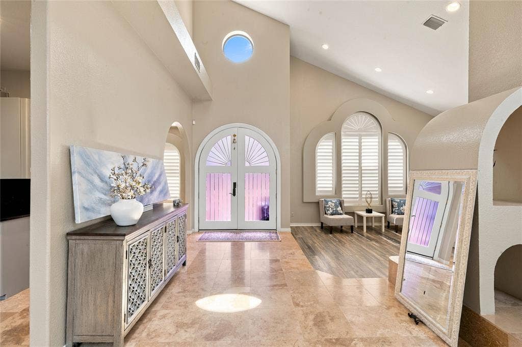 5057 Trail Lake Drive, Plano, TX 75093 Bright, elegant foyer with soaring ceilings and distinctive arched details.