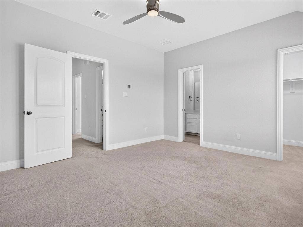 6504 Dynamite Drive, McKinney, TX 75070 Carpeted flooring, ceiling fan, white paneled doors, and a walk-in closet