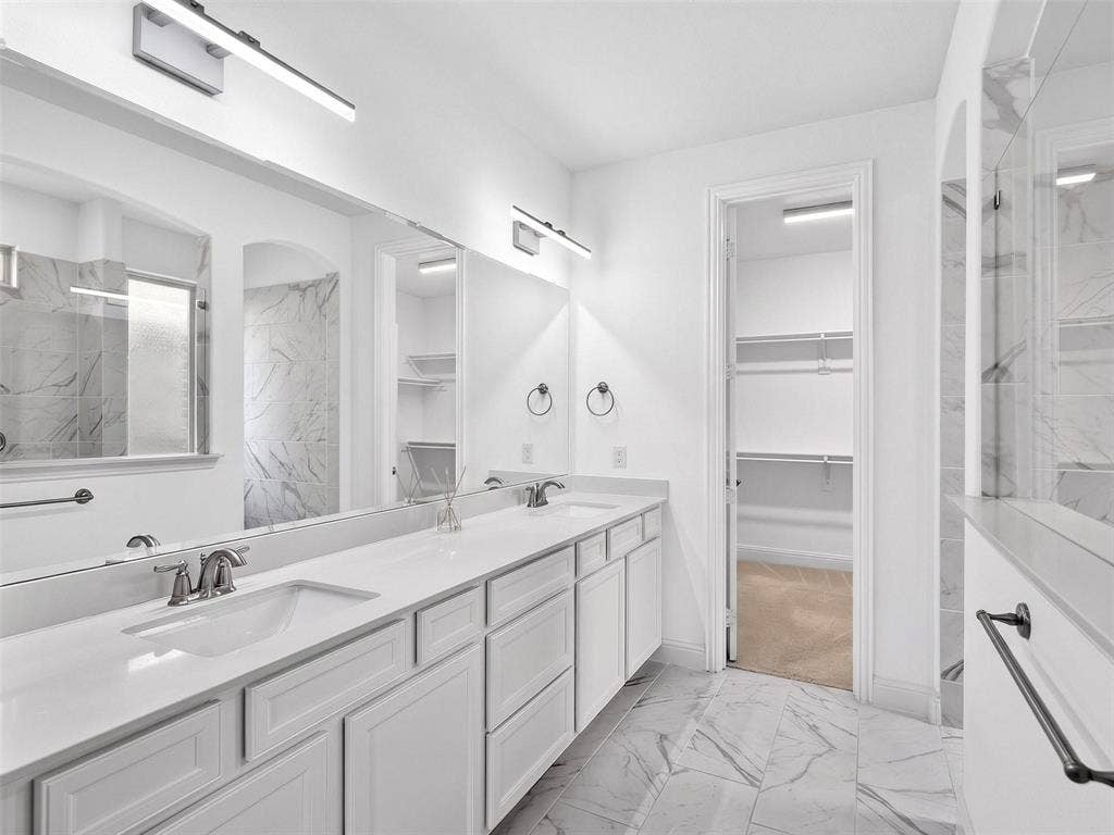 6504 Dynamite Drive, McKinney, TX 75070 Dual vanity with white cabinetry, integrated sinks, and linear light fixtures
