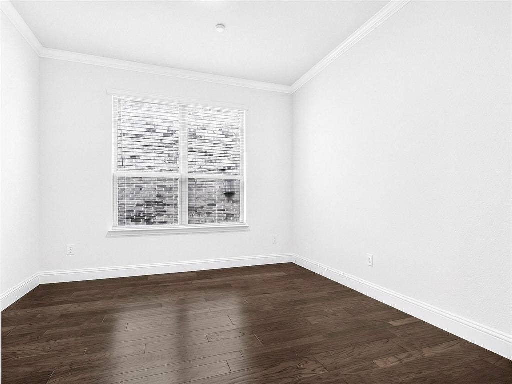 6504 Dynamite Drive, McKinney, TX 75070 Hardwood-finish flooring, white painted walls, crisp white crown molding, and a double-paned window with horizontal blinds