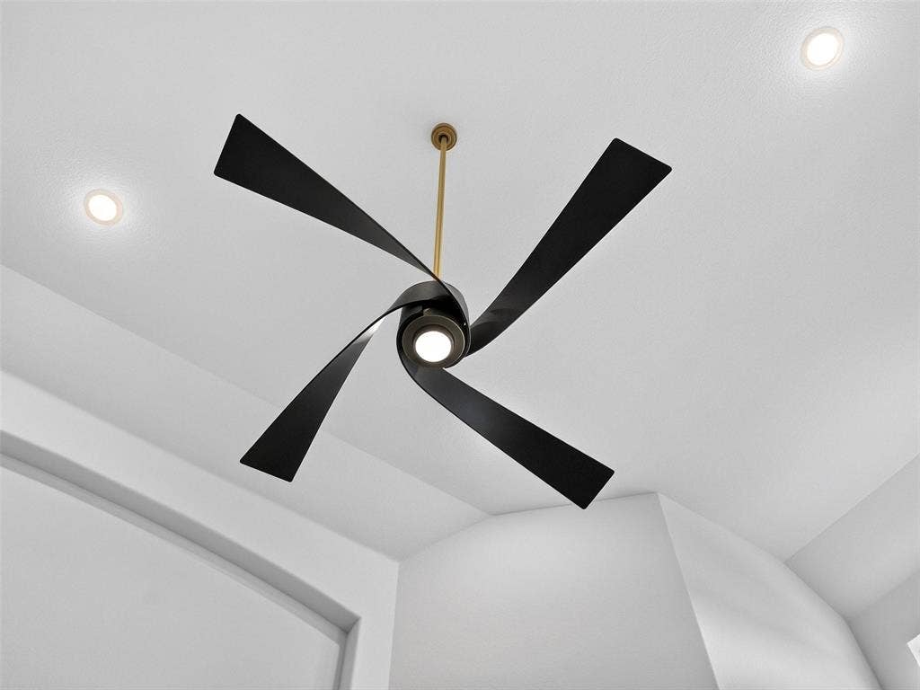 6504 Dynamite Drive, McKinney, TX 75070 Modern ceiling fan with black blades and integrated lighting