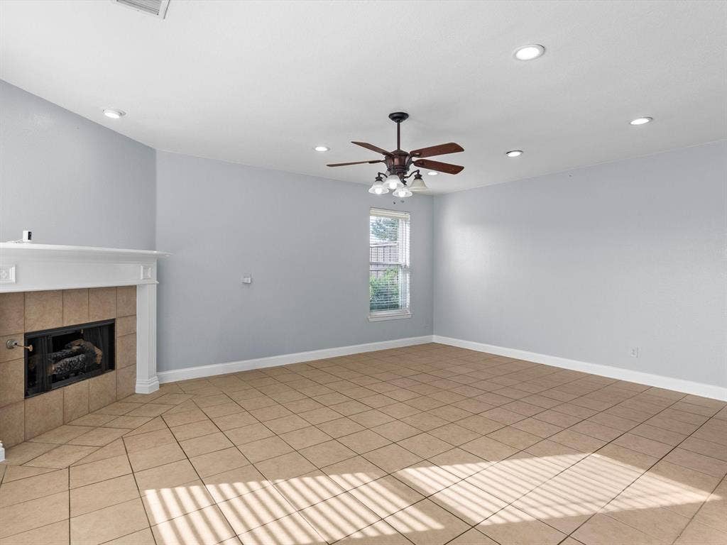 7302 San Carlos Drive, Rowlett, TX 75089 Tiled flooring, fireplace with mantel, recessed lighting, ceiling fan with light fixture, and window with horizontal blinds