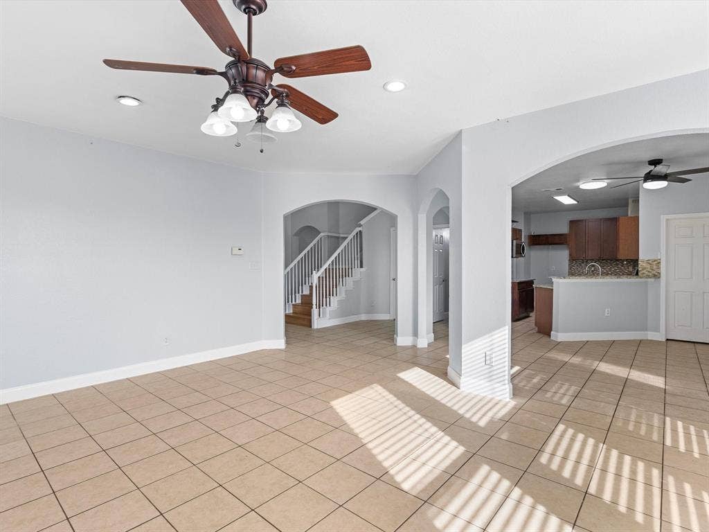 7302 San Carlos Drive, Rowlett, TX 75089 Expansive tiled flooring throughout, complemented by arched doorways