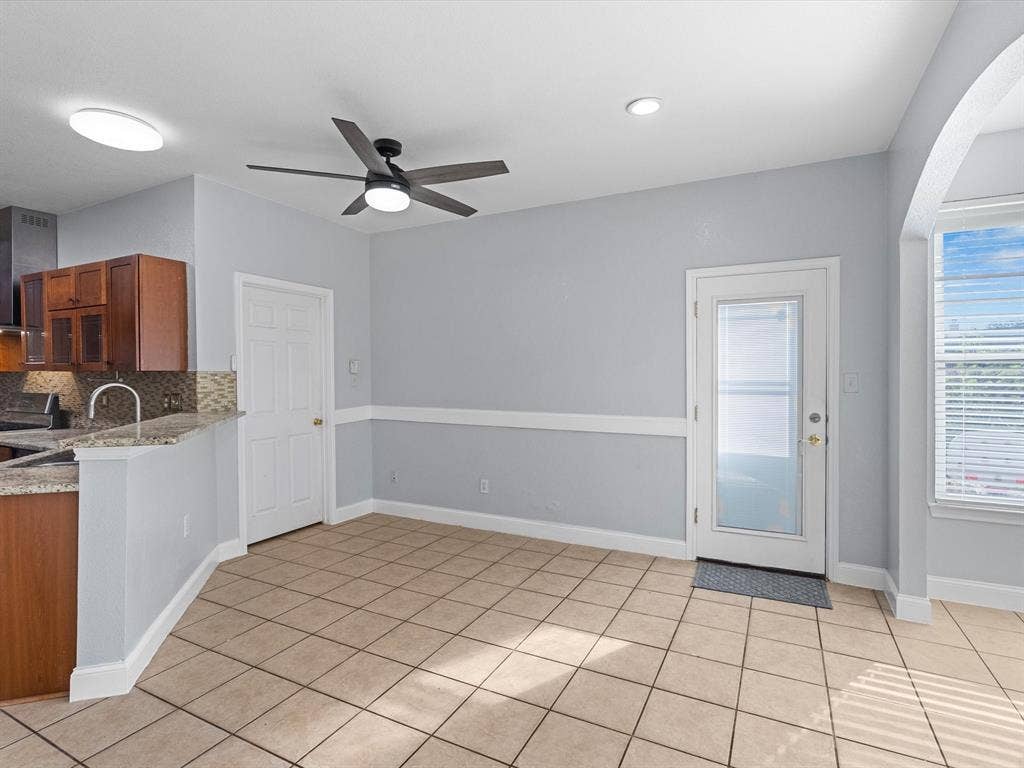 7302 San Carlos Drive, Rowlett, TX 75089 Tile flooring, wood cabinets, granite countertops, ceiling fan, and recessed lighting