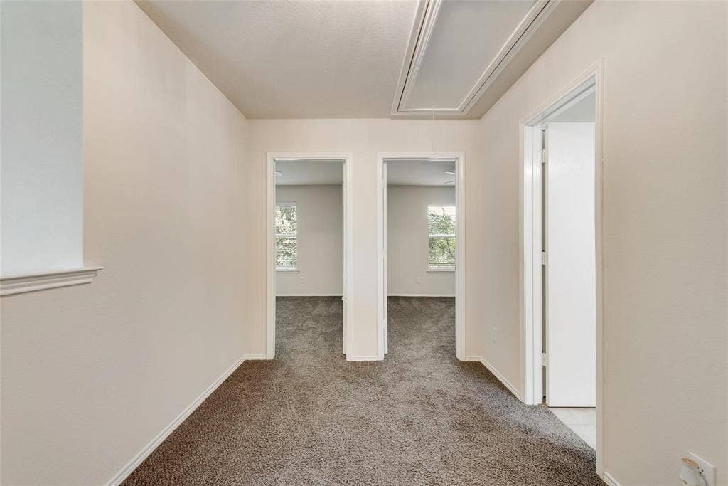 4541 Woodsboro Lane, Plano, TX 75024 Carpeted hallway with light-toned walls