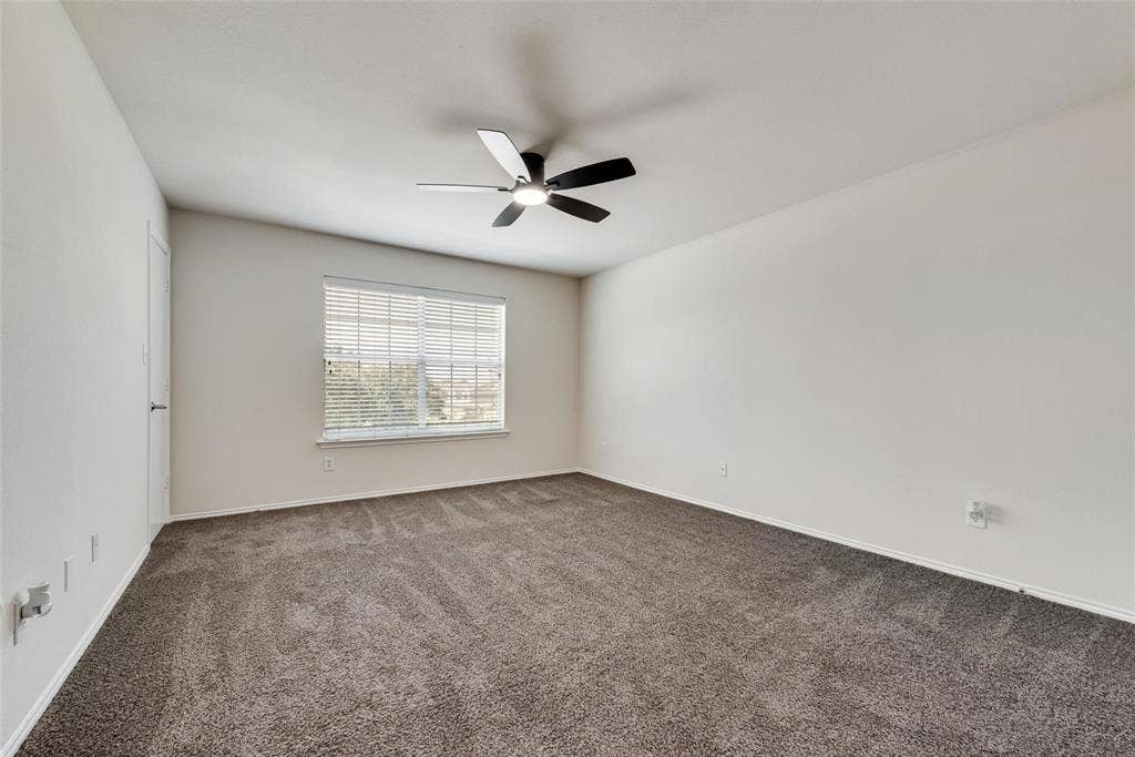 4541 Woodsboro Lane, Plano, TX 75024 White walls, carpet flooring, window with blinds, and a ceiling fan with integrated lighting