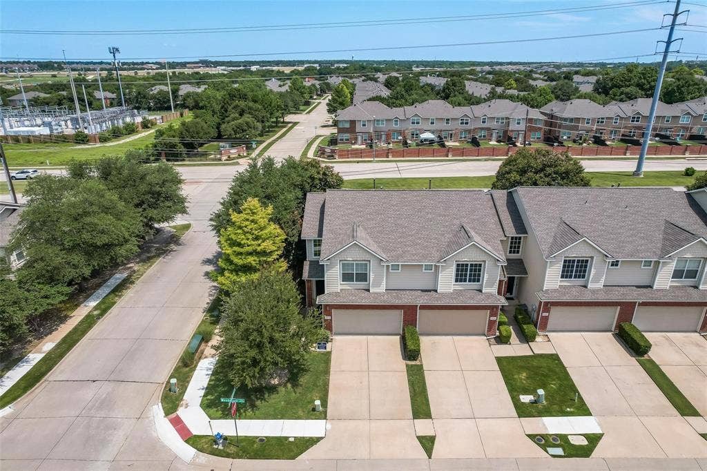 4541 Woodsboro Lane, Plano, TX 75024 Two-story townhome with a dark gray shingle roof and light-colored siding