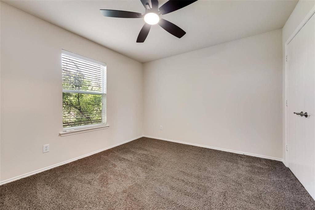 4541 Woodsboro Lane, Plano, TX 75024 Neutral tone walls, brown carpeting, and a window with horizontal blinds