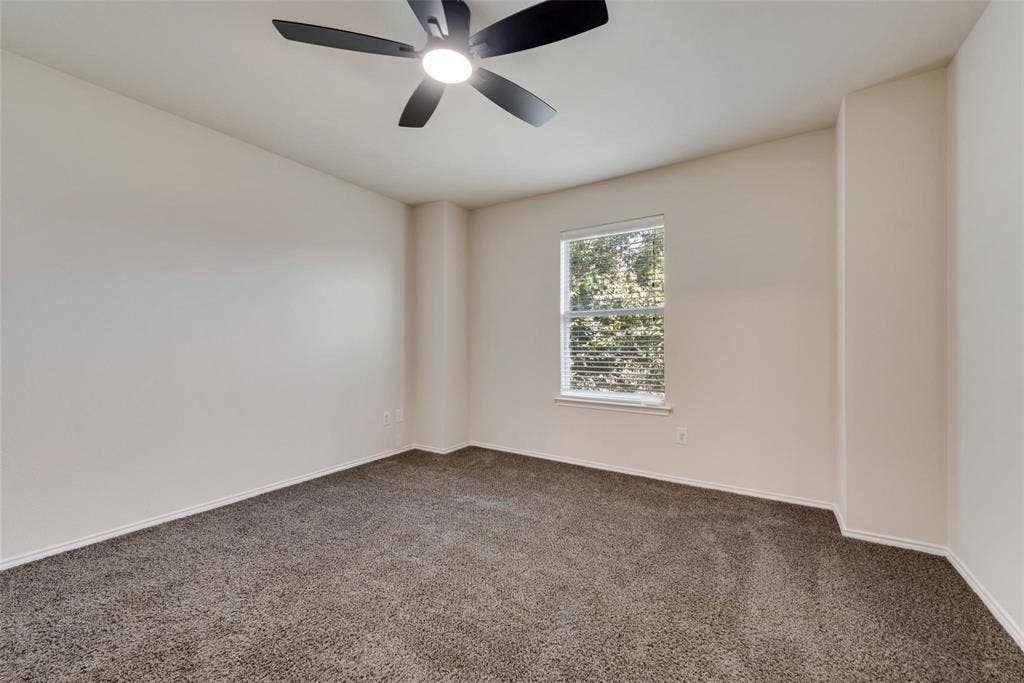 4541 Woodsboro Lane, Plano, TX 75024 Neutral wall color, ceiling fan with integrated lighting, window with blinds, and carpet flooring