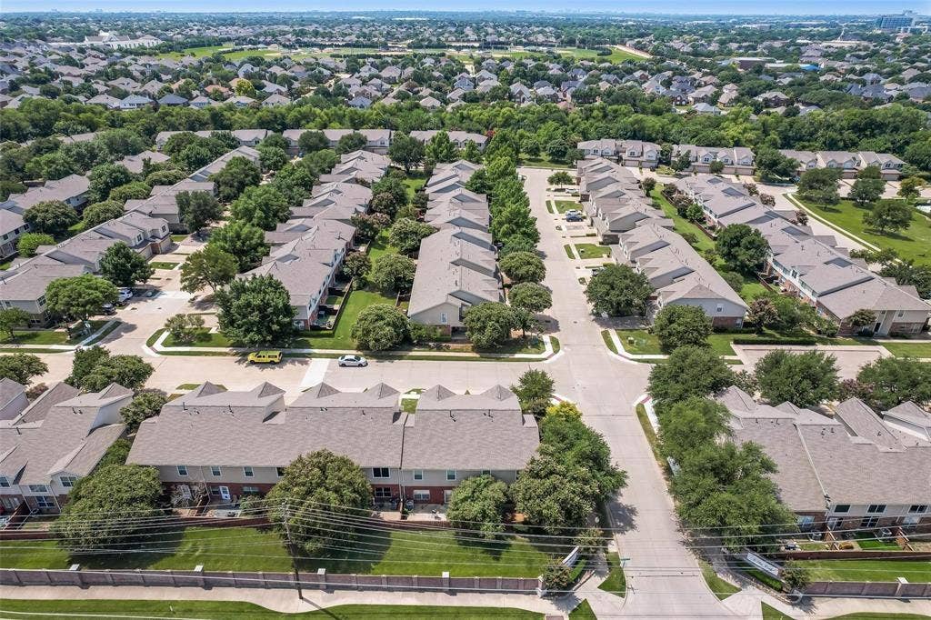 4541 Woodsboro Lane, Plano, TX 75024 Residential community featuring multiple two-story structures, paved roadways, and landscaped grounds