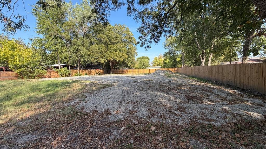 307 S Rike Street, Farmersville, TX 75442 Expansive lot featuring a level grade, new wood fencing, and mature trees along the perimeter