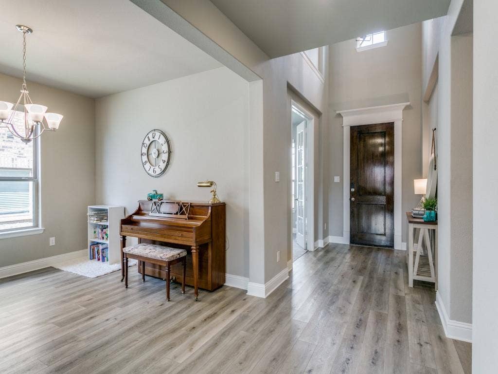 Welcoming foyer featuring soaring ceilings and luxury vinyl plank flooring
