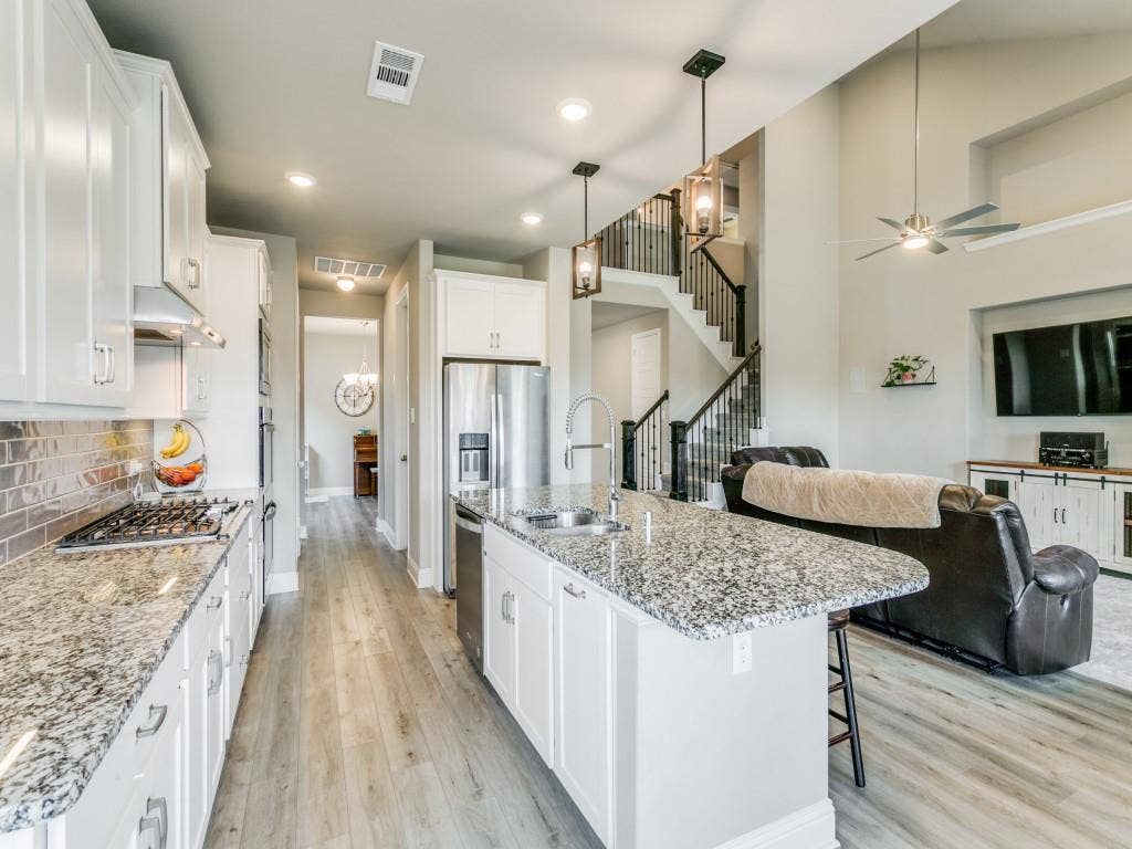 This beautiful kitchen features custom cabinets including built-in spice drawers!