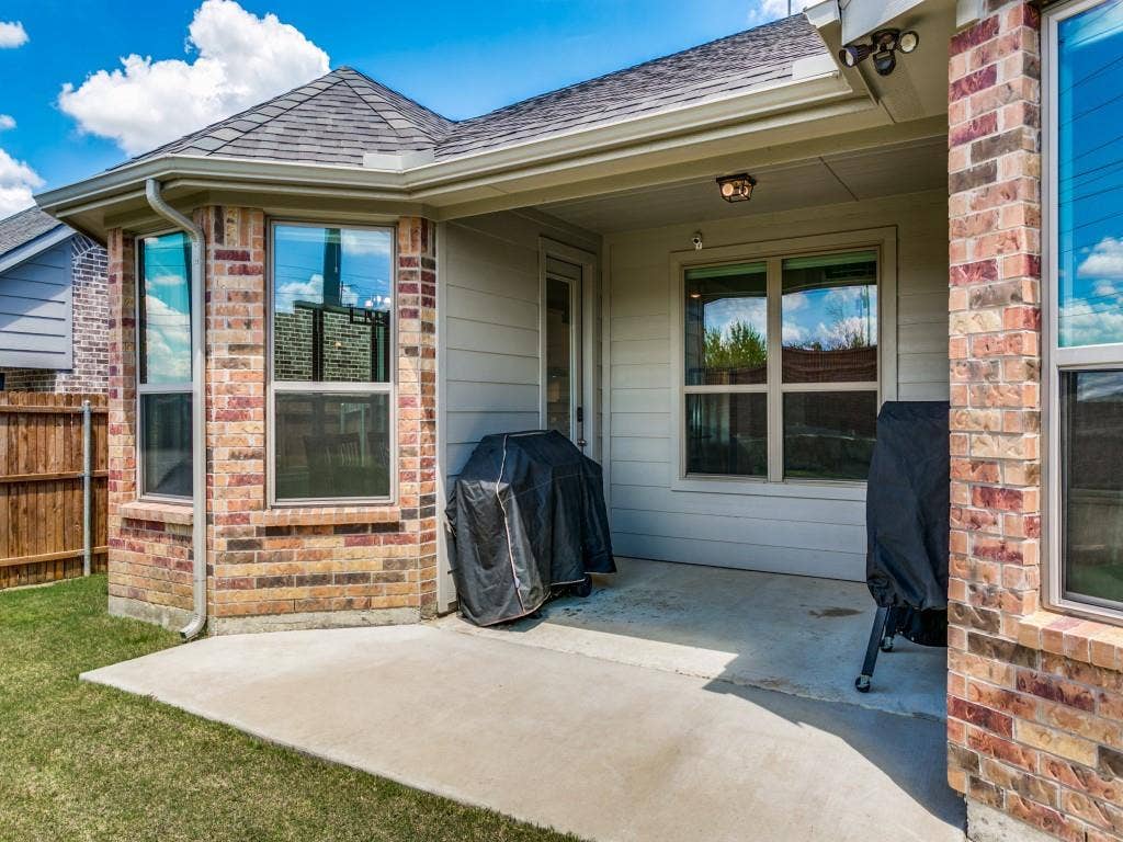 Extended covered patio in this private backyard