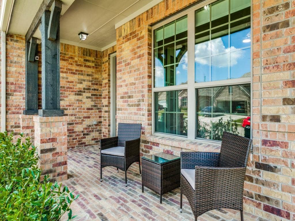 Charming covered front porch, perfect for morning coffee or enjoying a beautiful Texas sunset