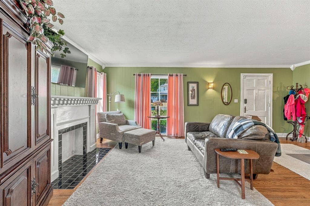 Light filled living room with original hardwood flooring.