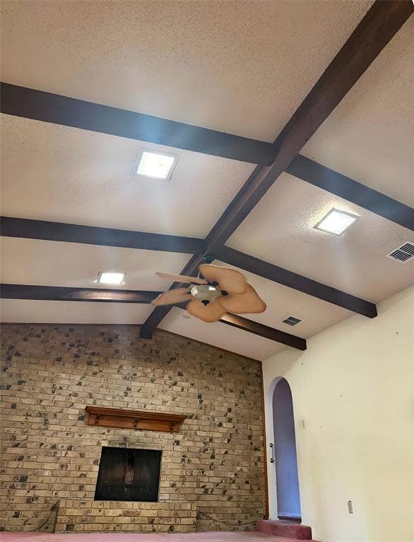 148 Crockett Lane, Hewitt, TX 76643 Spacious great room featuring a grand brick fireplace and beautiful vaulted, beamed ceiling.'