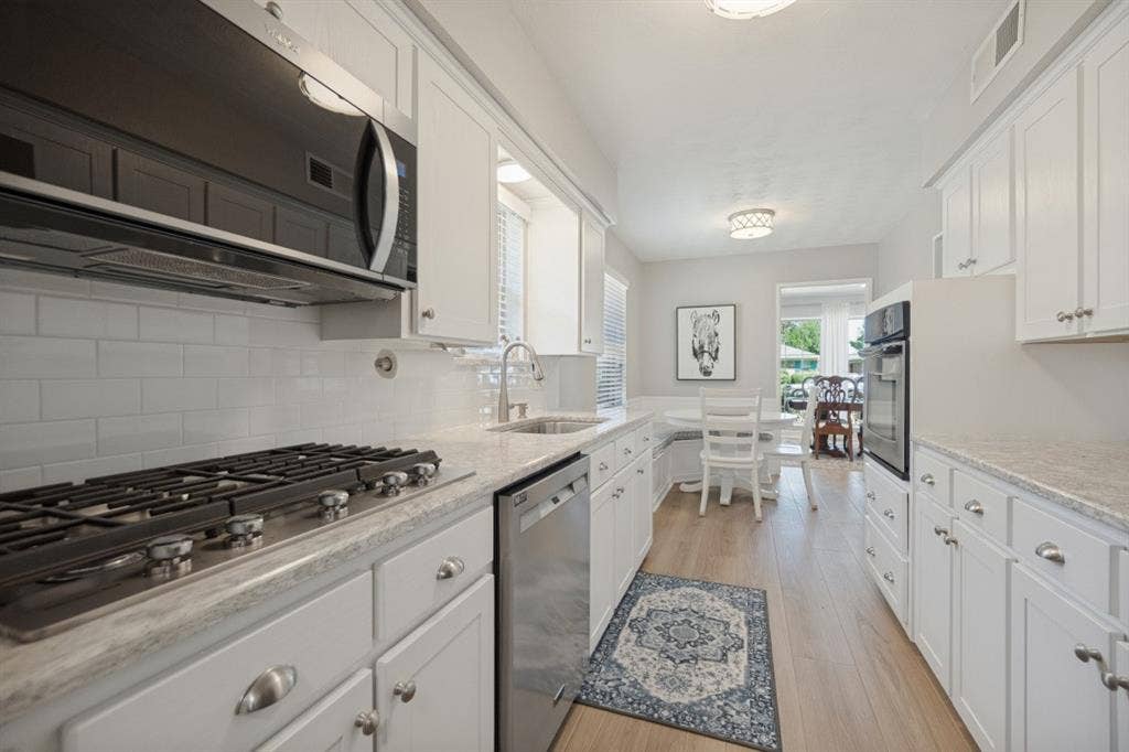 Remodeled Kitchen has white cabinets, quartz countertops, SS appliances and sink, and a 5-burner gas cooktop. Just what the chef ordered.
