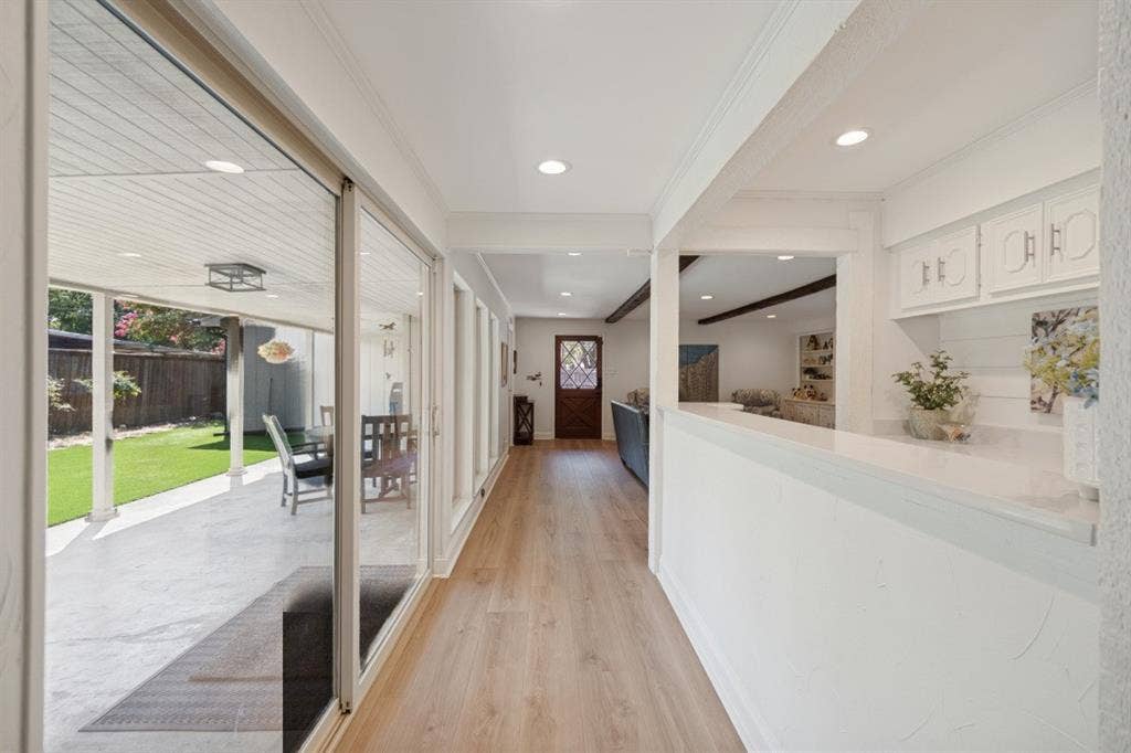 Wall of floor-to-ceiling windows and slider door = 17 ft. long and has morning sun.