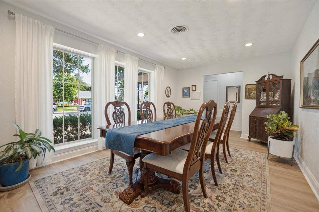 Dining Room has floor-to-ceiling windows overlooking the front lawn.