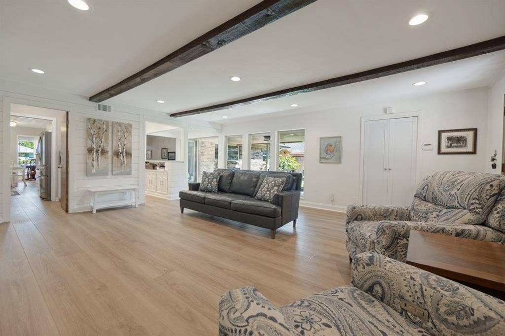 Family Room opens to the office or dry bar, utility room with pantry cabinets, thru the slider door to the covered patio & lawn, and out the back door to the garage & other parking areas.