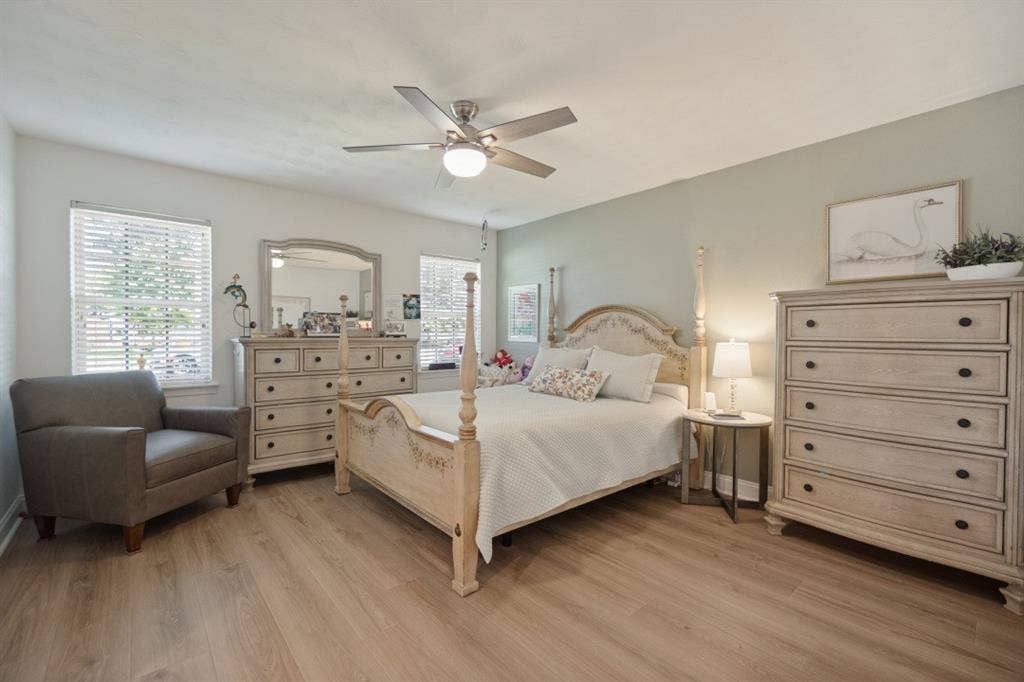 Primary Bedroom has a ceiling fan, nice windows, walk-in closet, LVP floor, & ensuite bath.