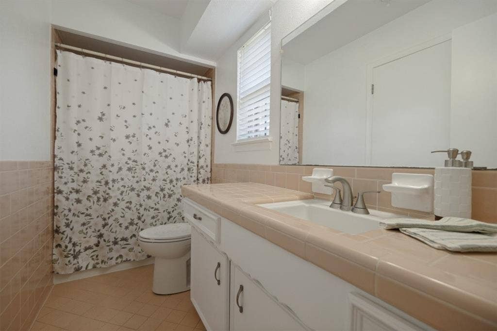 Bathroom 2 has a tub with shower, comfort-height toilet, & opens to BR2 and BR3.