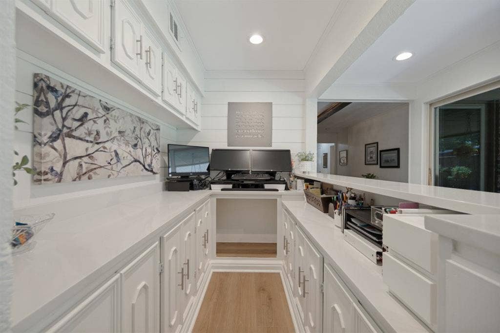 Office with 10' of white cabinets x 2 sides + overhead cabinets + quartz countertop. Could also be a serving area or dry bar.