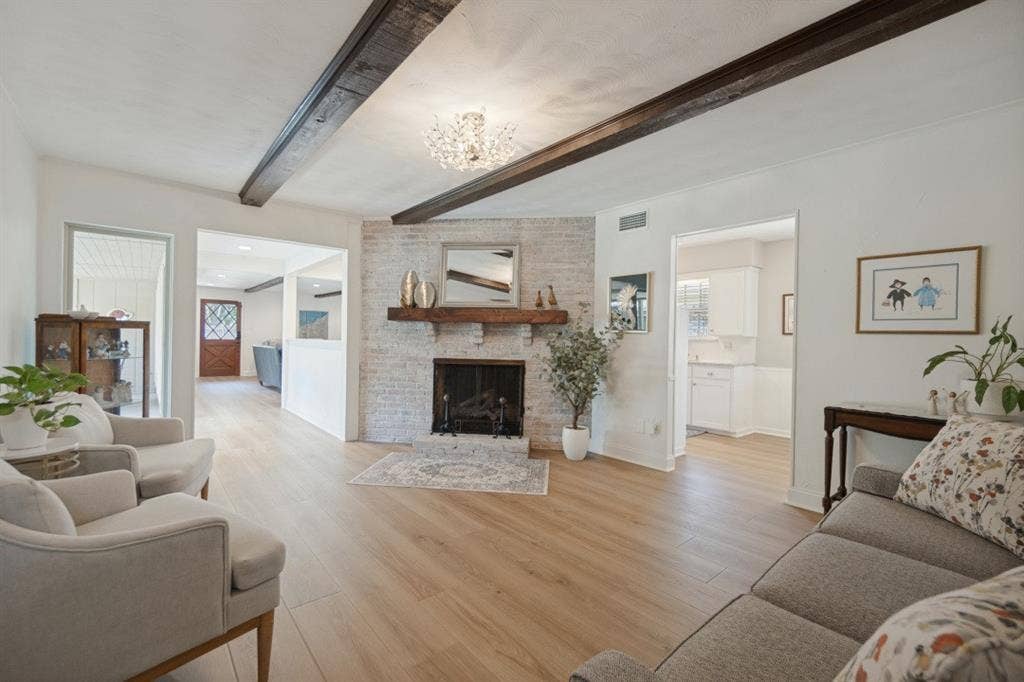 Focal Point of the Living Room is the brick fireplace with gas logs & a raised hearth.
