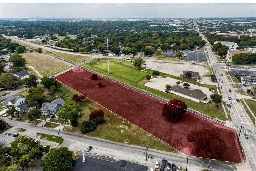 600 W Avenue D, Garland, TX 75040 Expansive parcel with clear boundaries, bordered by established roads and mature trees