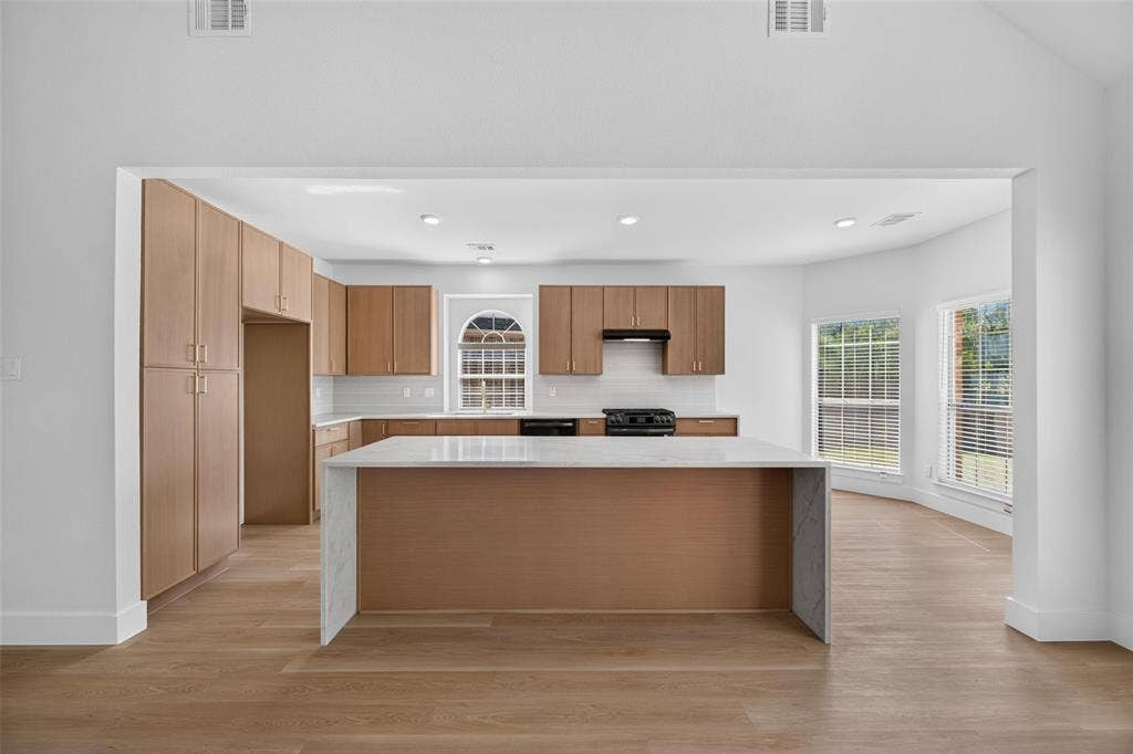 705 N Jordan Road, McKinney, TX 75071 Kitchen featuring wood-finish cabinetry, white subway tile backsplash, white countertops, and stainless steel appliances