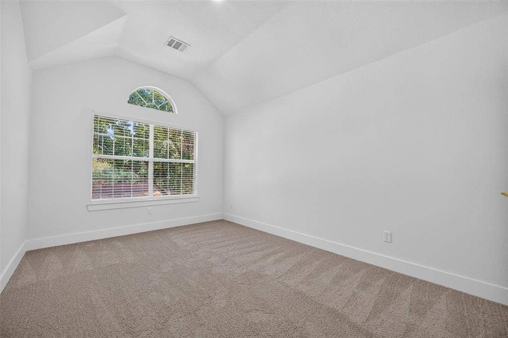 705 N Jordan Road, McKinney, TX 75071 Vaulted ceiling, arched transom window, large picture window, carpeted flooring, white walls