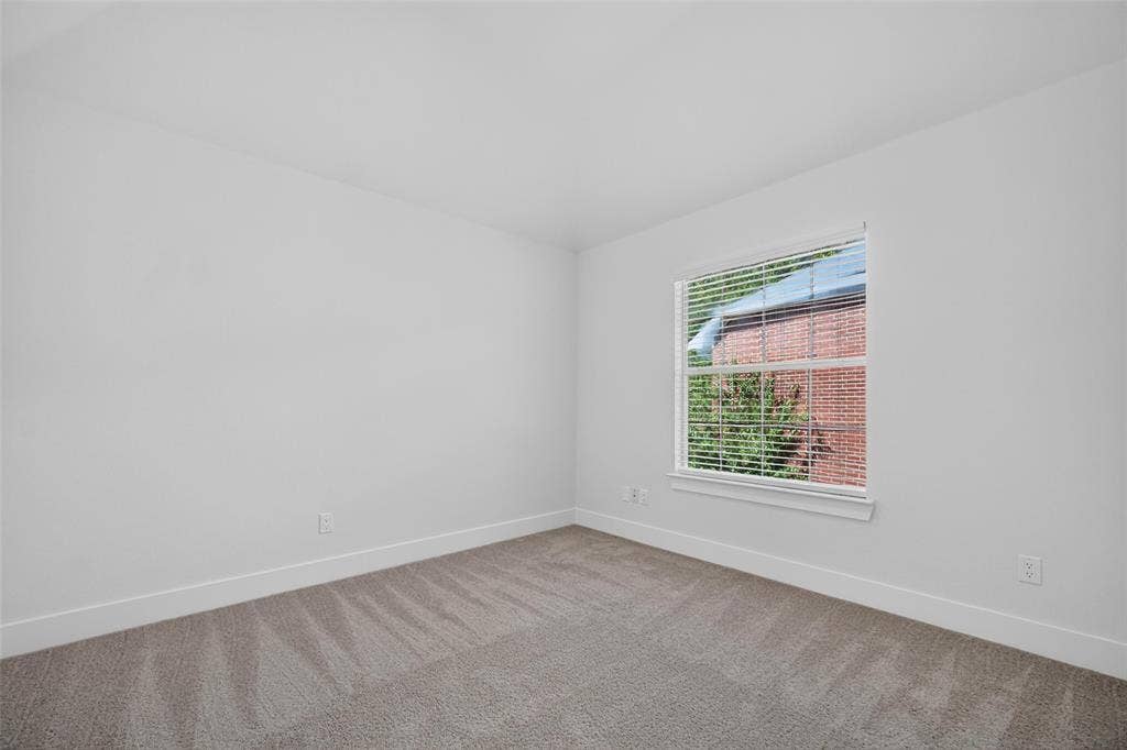 705 N Jordan Road, McKinney, TX 75071 Light gray carpeting, white walls, and a single window with white blinds