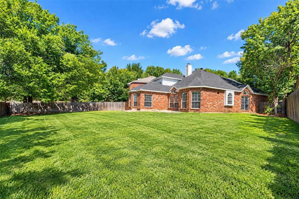 705 N Jordan Road, McKinney, TX 75071 Expansive lawn with mature trees and wood fencing