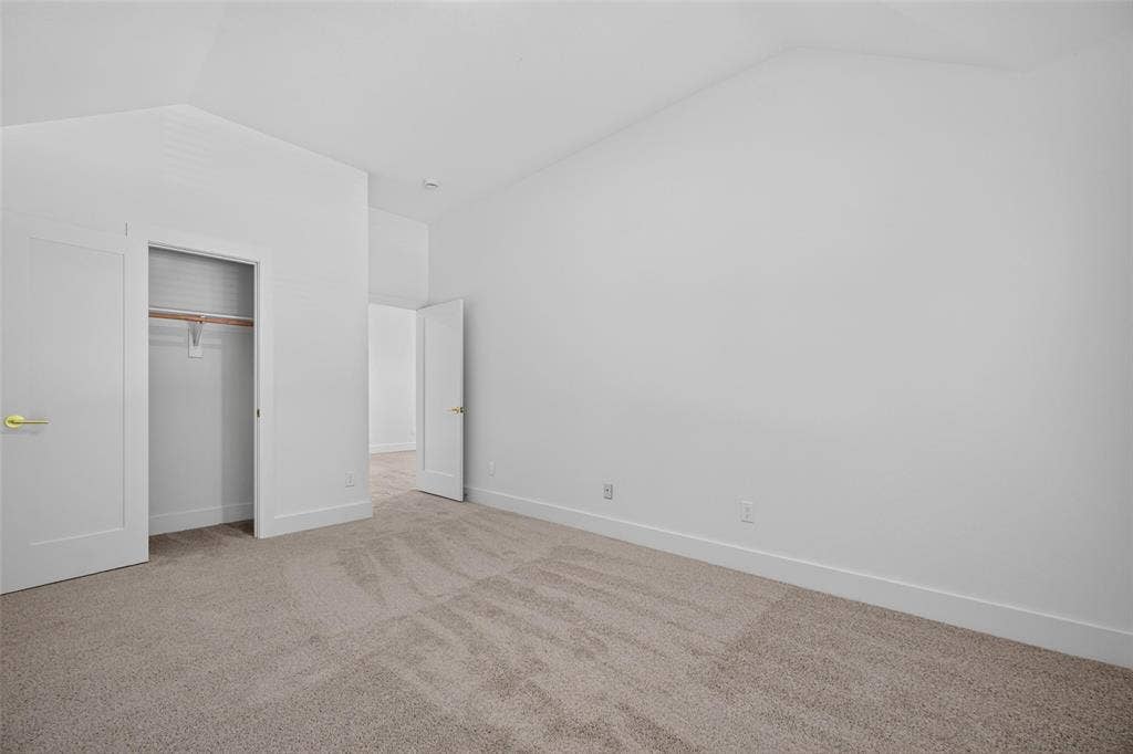 705 N Jordan Road, McKinney, TX 75071 Vaulted ceiling, neutral wall paint, light-toned carpeting, white trim, and a functional closet