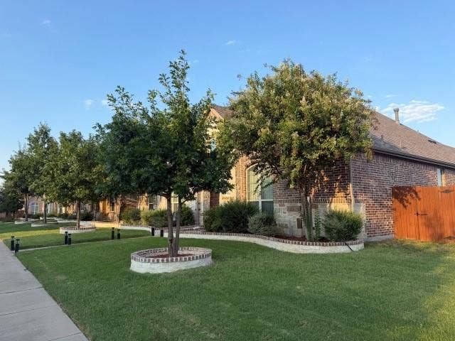 7610 Graystone Drive, Sachse, TX 75048 Brick and stone exterior with an arched window