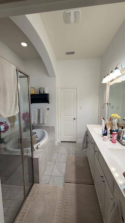 7610 Graystone Drive, Sachse, TX 75048 Dual vanity with undermount sinks, a built-in soaking tub, and a separate glass-enclosed shower
