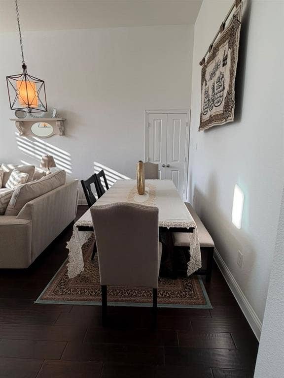 7610 Graystone Drive, Sachse, TX 75048 Dark wood-finish flooring with crisp white baseboards, a pendant light fixture, and a built-in wall shelf