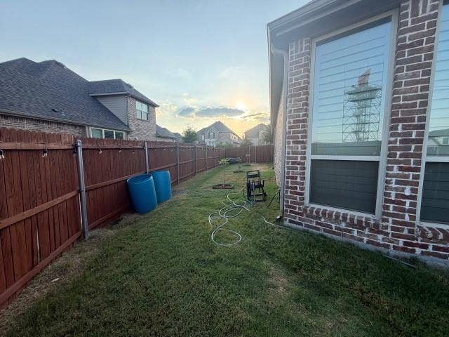7610 Graystone Drive, Sachse, TX 75048 Brick exterior with large windows, manicured lawn, and wood privacy fencing