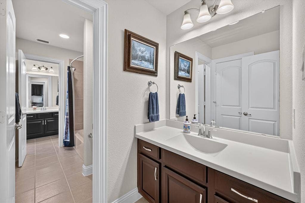 Dual vanities with white countertops, undermount sinks, and brushed nickel faucets