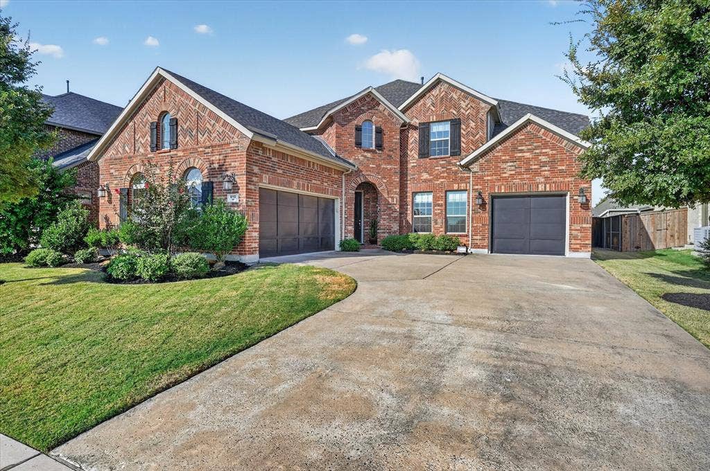 Brick exterior with varying patterns, arched windows, and dark shutters