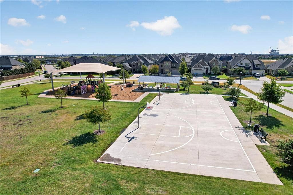 Community park with a basketball court, playground, and shaded seating areas