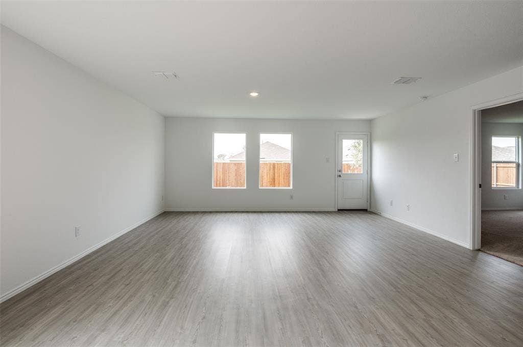1708 Sims Street, McKinney, TX 75071 Empty room with wood-type flooring