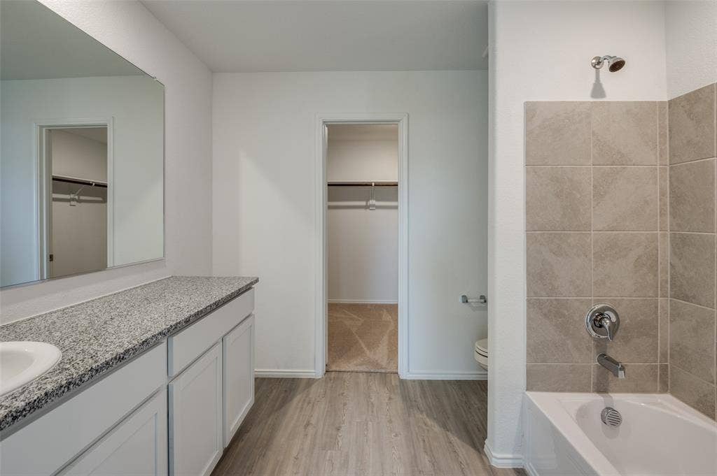 1708 Sims Street, McKinney, TX 75071 Bathroom featuring hardwood / wood-style floors, vanity, and toilet