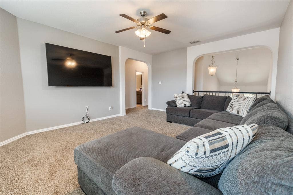 3605 Barby Court, Midlothian, TX 76065 Spacious room featuring carpeting, a ceiling fan with integrated lighting, and an arched doorway