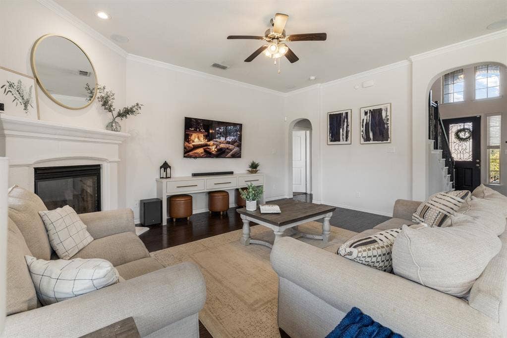 3605 Barby Court, Midlothian, TX 76065 Living area featuring a fireplace with a white mantel, dark wood-finish flooring, and white walls